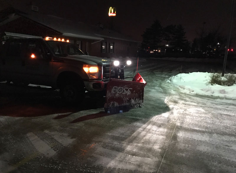 Truck Plowing Snow in Akron Ohio Commercial Parking Lot